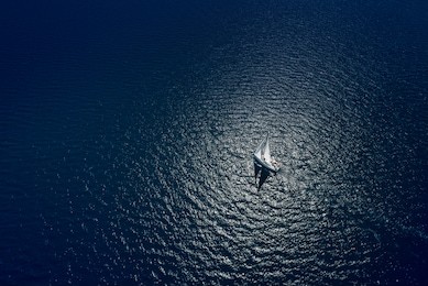 amazing view to yacht sailing in open sea at windy day. drone view - birds eye angle. yachting theme.