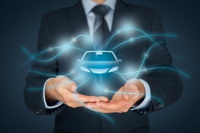 car (automobile) insurance and car services concept. businessman with offering gesture and icon of car.
