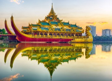 golden karaweik palace reflecting on kandawgyi lake looks like an ancient royal barge. sunset time. yangon, myanmar 
