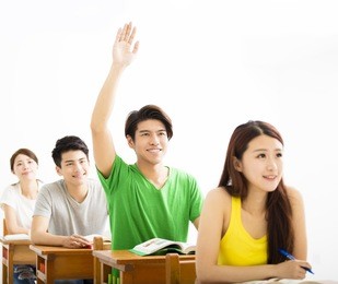 college student raise hand for question in classroom