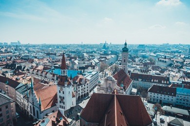 scenic overview of city of munich with old city hall and steeple tower of st peters church on sunny day, munich, germany