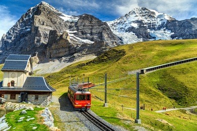 famous electric red tourist train coming down from the jungfraujoch station(top of europe) in kleine scheidegg,bernese oberland,switzerland,europe
