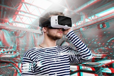 man wearing virtual reality goggles. welding factory. vr glasses. 360 degrees. virtual reality headset. vr game. wearing virtual reality goggles. smartphone with vr. virtual reality video.