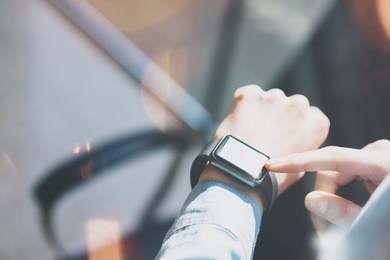 closeup photo woman relaxing modern loft studio.using generic design smart watch.female hands touching screen smartwatch.manage free time process. horizontal mockup. burred background. film effects.