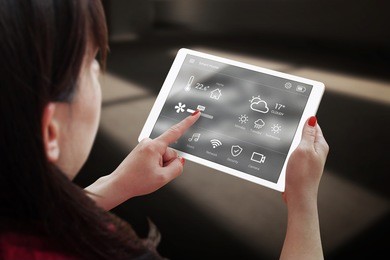 smart home control on tablet. interior of living room in the background.