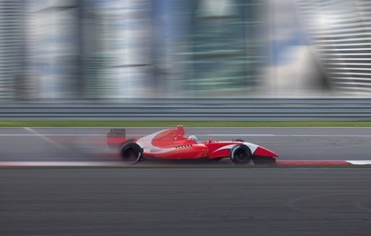  formula 2.0 race car racing at high speed with motion blur on the background of the city in the day