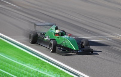  formula 2.0  race car on speed track with motion blur at sunny day