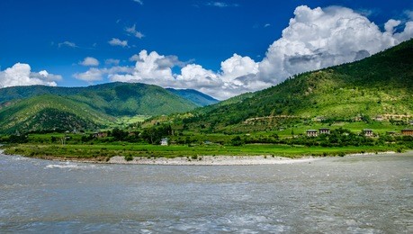 beautiful scenery distant view punakha dzong at the confluence of mo chu and pho chu rivers in punakha, bhutan