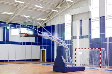 part of sports gym with modern basketball upright and soccer goal