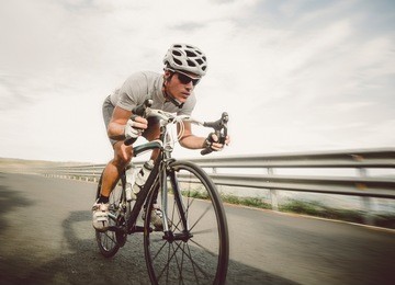 cyclist pedaling on a racing bike outdoors in a sunny day