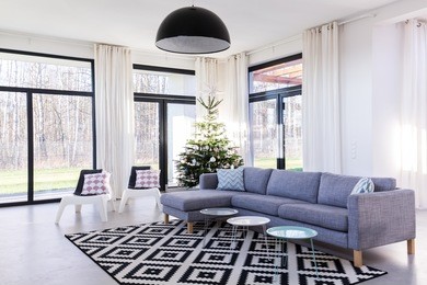 spacious living room with large sofa and window wall system.