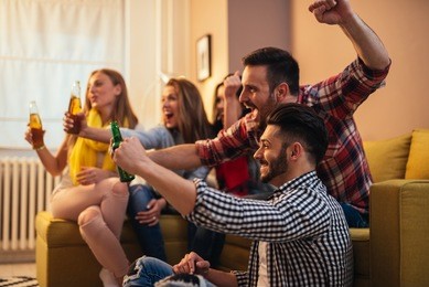friends enjoying a great football game and drinking beer.