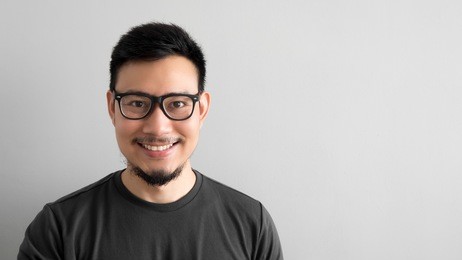 happy asian man with eyeglasses.