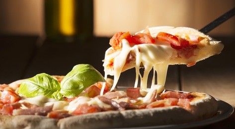 pizza with bacon on the wooden table