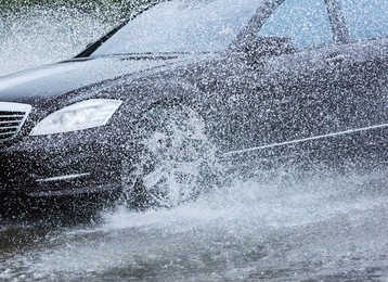 motion car rain big puddle of water spray from the wheels