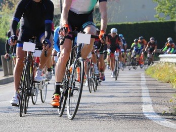 many racing bikes led by cyclists during the street race