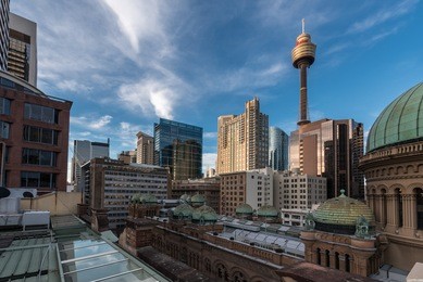 sydney two famous landmarks - queen victoria building and sydney tower during the evening with bright light and blue sky with some high clouds