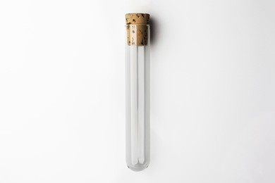 empty glass transparent test tube closed with cork on white background