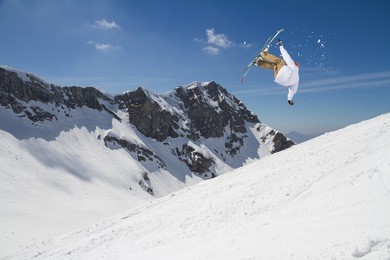 ski rider jumping on snowy mountains. extreme ski freeride sport.