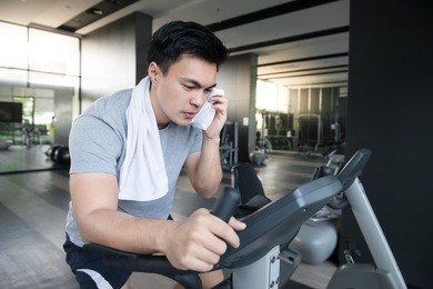 a man doing indoor biking in a fitness club