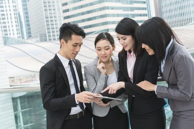 group of business people work together with pad