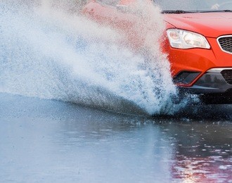 motion car rain big puddle of water spray from the wheels