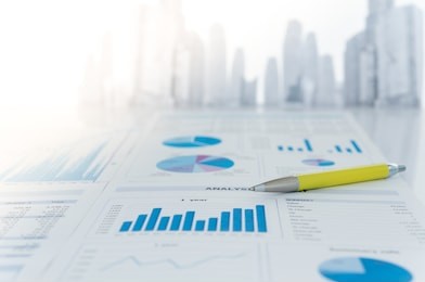 pen and chart analysis business report on desk of funds manager.