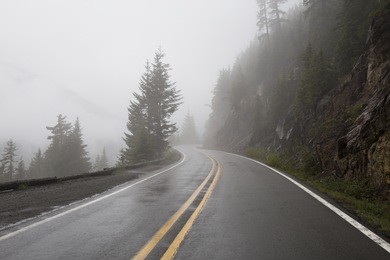 mather memorial pkwy (410) in mt rainier national park during a foggy rainy morning.