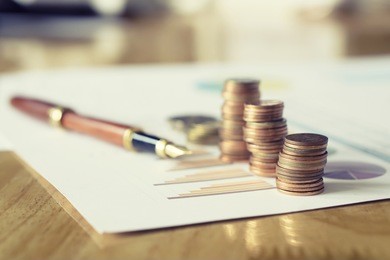 saving stack coins money concept,graph,chart  document and pen on desktop desk in hipster office,copy space.selective focus,vintage color
