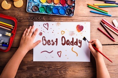 unrecognizable girl painting picture for her dad, fathers day. concept for fathers day celebration. best father. child and father concept. daughter hands with card for daddy. girl and father. 