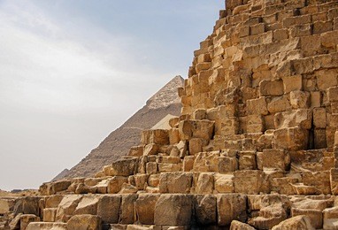 ancient egyptian pyramid of giza against the sky and close up of the pyramid blocks