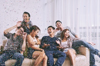 group of asian friends having fun at home party