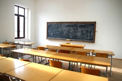 traditional classroom interior with blackboard and desks