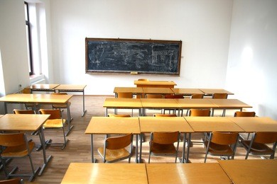 traditional classroom interior with blackboard and desks