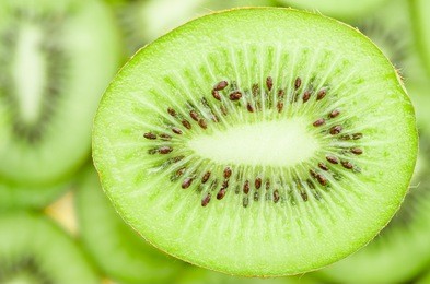 slices of kiwi fruit on kiwi background.
