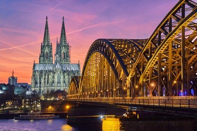 cologne cathedral and hohenzollern bridge at sunset / nighttime