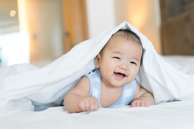 portrait of a newborn asian baby on the bed 