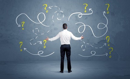 a salesman in doubt can not find the solution to the problem concept with curvy lined arrows and question marks drawn on urban wall