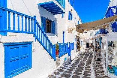 a view of whitewashed cycladic street in beautiful mykonos town, cyclades islands, greece