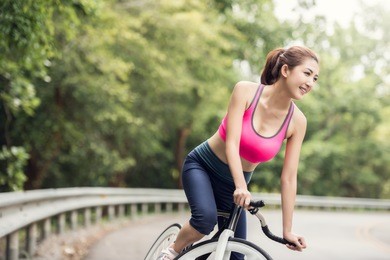 asian woman on cycle ride in countryside