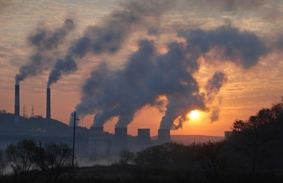 factory pipe polluting air against sunset, environmental problems, smoke from chimneys