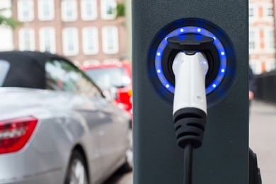 socket for electrical car battery charger with blue led lights, selective focus