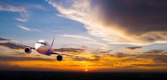 airplane with background of cloudy sky at sunset or sunrise, exploration conceptual