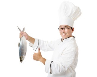 happy chef holding big fish isolated on white