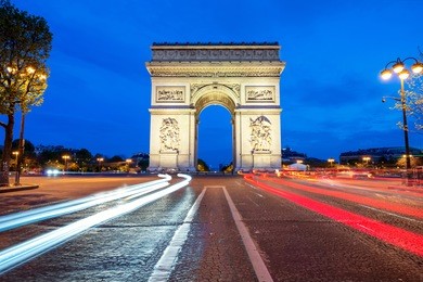 arc de triomphe at night in paris, france. 