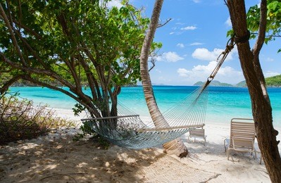 beautiful tropical beach with white sand, hammock, turquoise ocean water and blue sky at st john, us virgin islands in caribbean