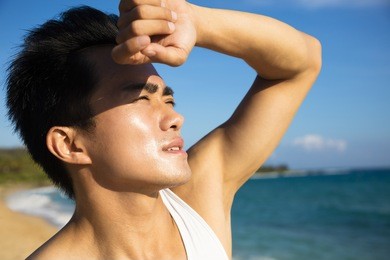 young man under hot summer heat wave