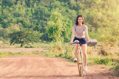 young asian woman with vintage bicycle in countryside nature landscape.