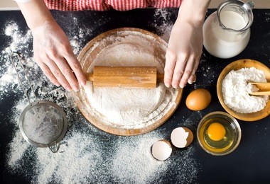 making dough by female hands at bakery