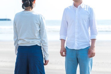 asian couple facing at the beach